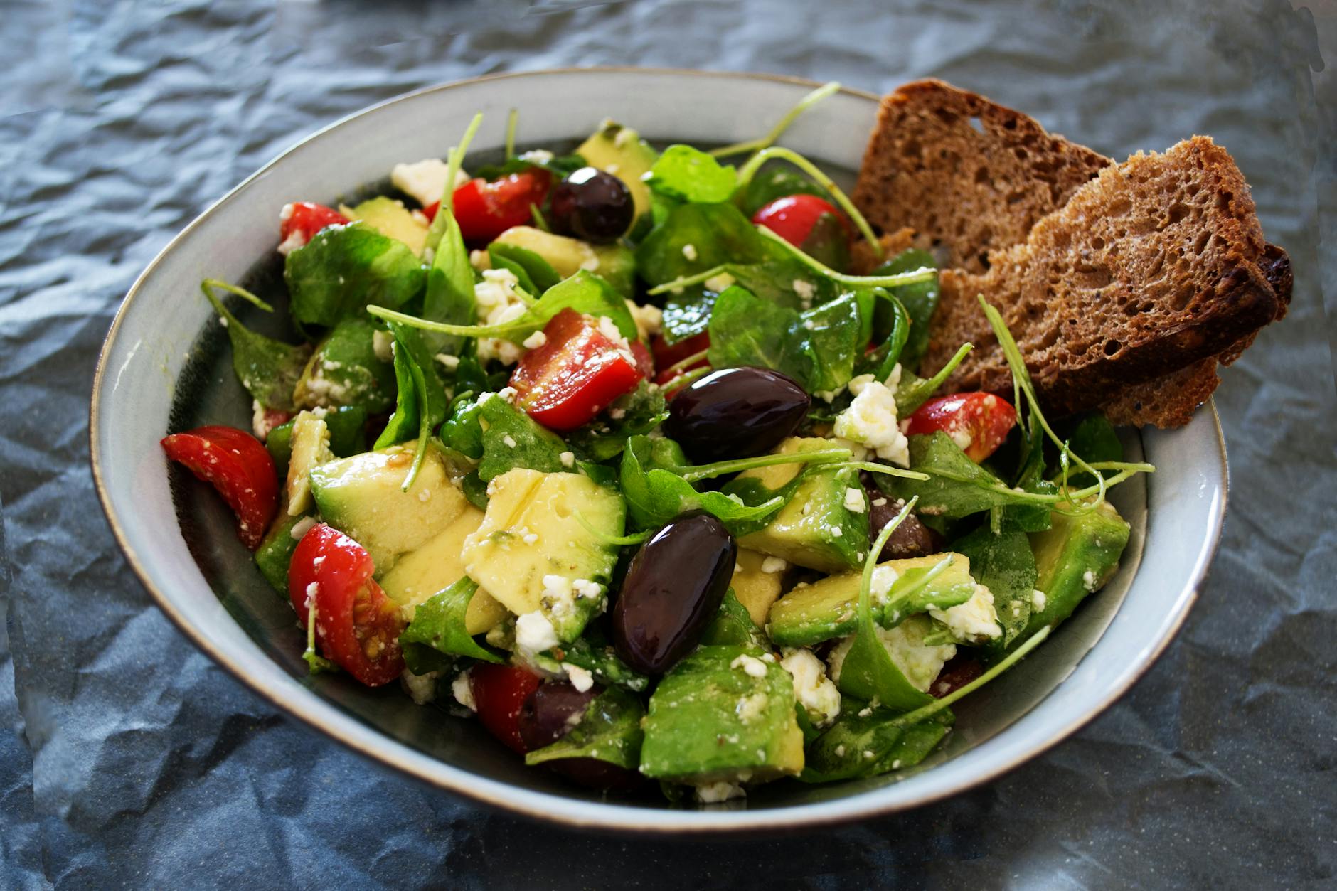 vegetable salad with wheat bread on the side